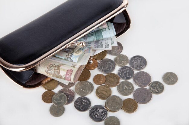 Ruble money in black purse on white background