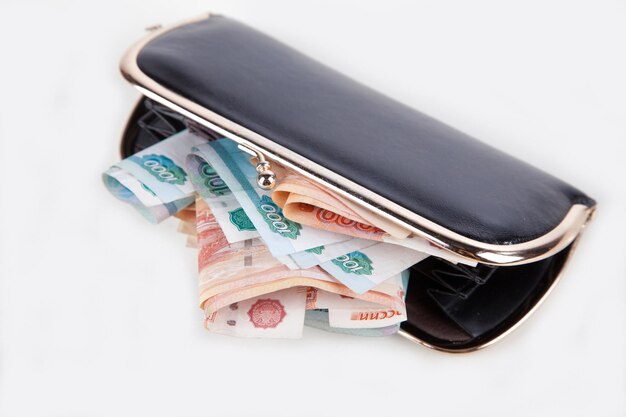 Ruble money in black purse on white background