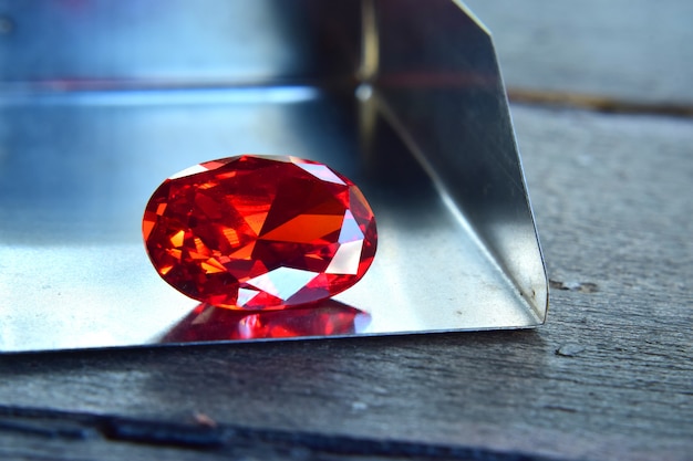 ruby Is a beautiful red gemstone on a wooden floor