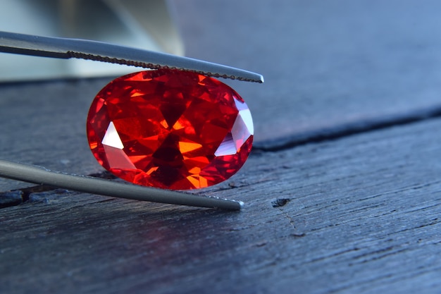 ruby Is a beautiful red gemstone on a wooden floor