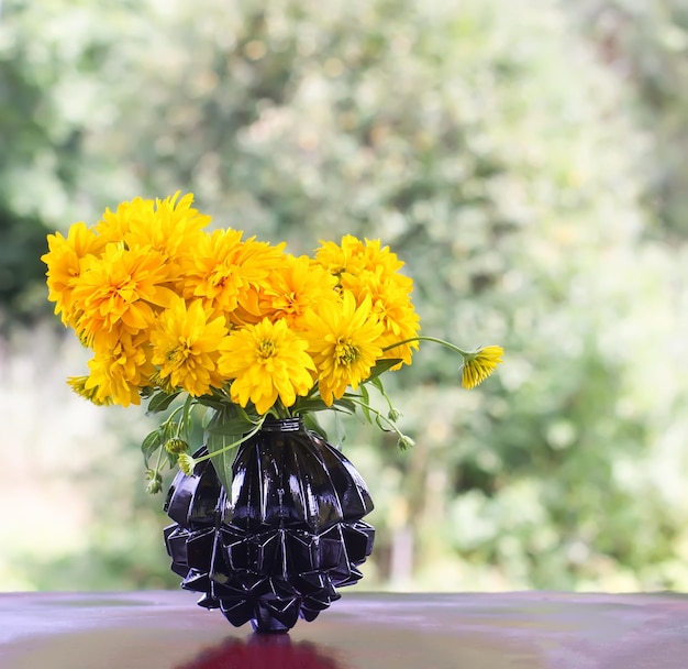 Rudbeckia laciniata golden ball yellow ornamental garden flowers Bouquet in a vase outdoors