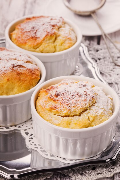 Ruddy cheese cupcakes with icing sugar closeup