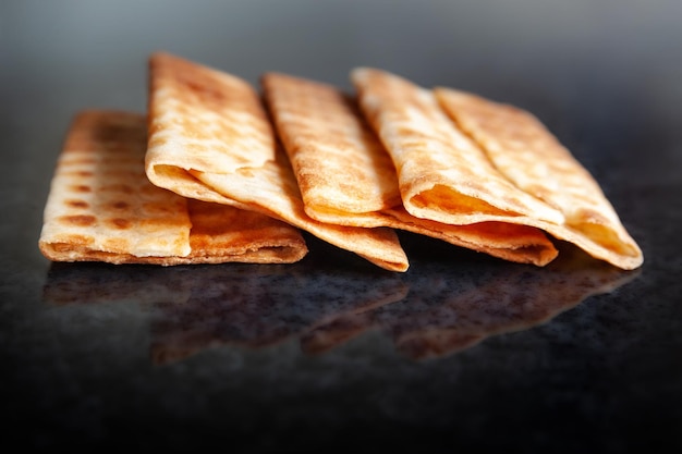 Ruddy dry biscuits on black marble Freshly baked cookies Selective soft focus