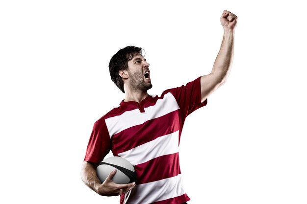 Rugby player in a red uniform celebrating.