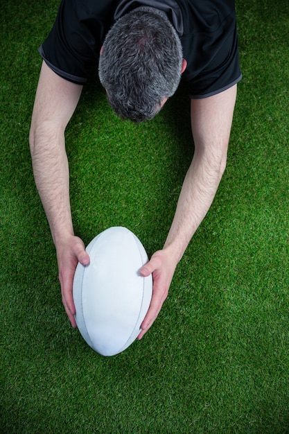 A rugby player scoring a try