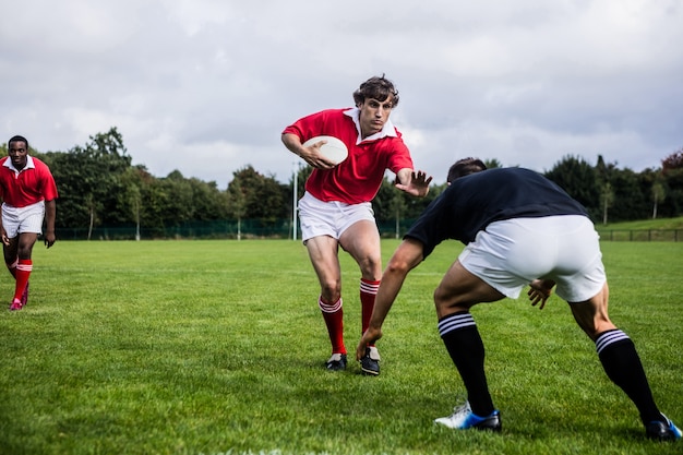 Rugby players tackling during game