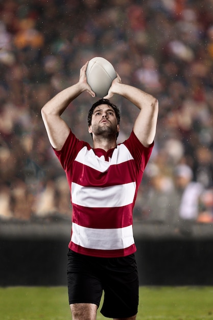 Rugbyspeler in een rood uniform.