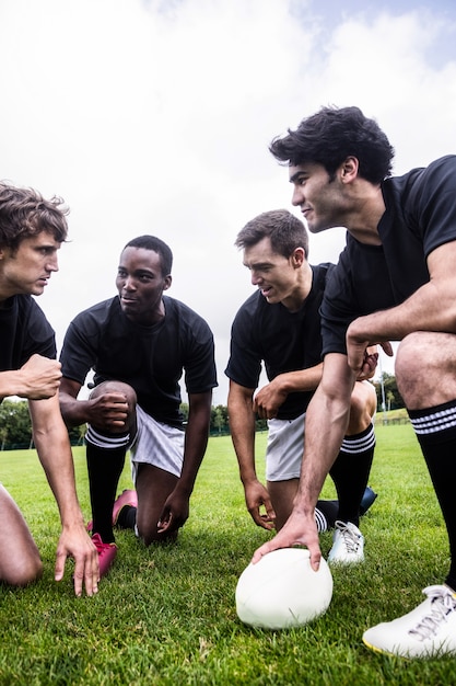 Foto rugbyspelers die hun tactieken bespreken