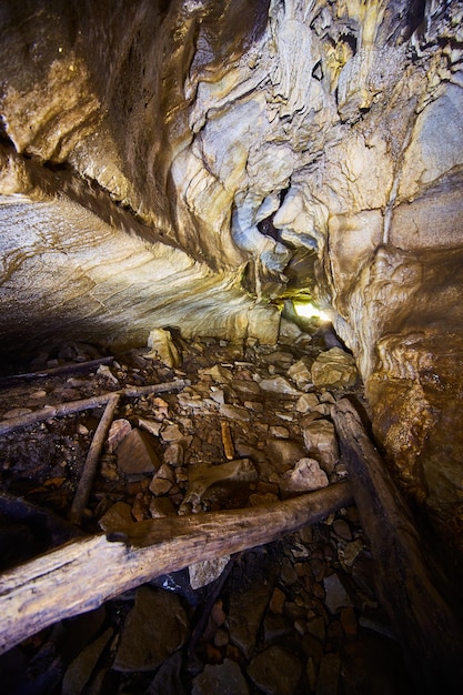 Rugged Cave Interior with Logs and Earthy Tones Low Angle View