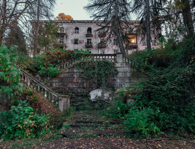 Ruined and abandoned hous with beautiful architecture in the Akarmara mining village in Abkhazia. Ghost city in the evening.