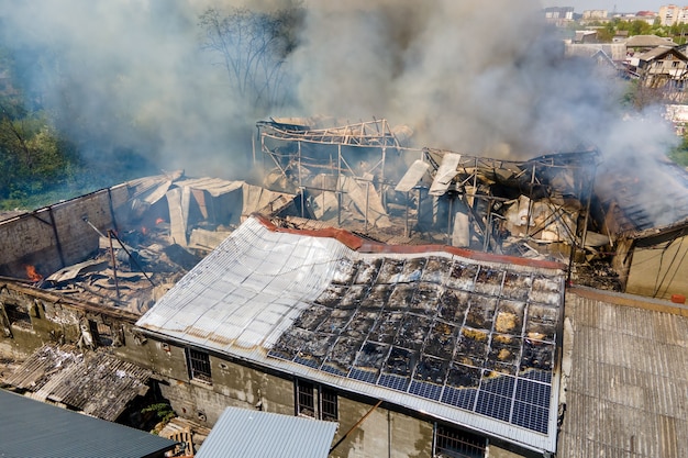 Ruined building on fire as example of rocket air strike result between Israel and Gaza in Middle East conflict.