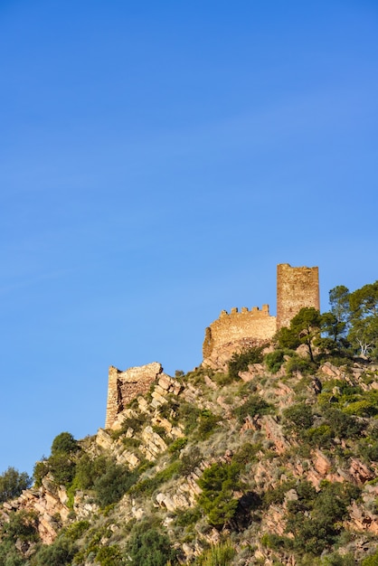 Ruined castle at the top of a mountain. Castell de Serra, Serras Castle Valencia, Spain.