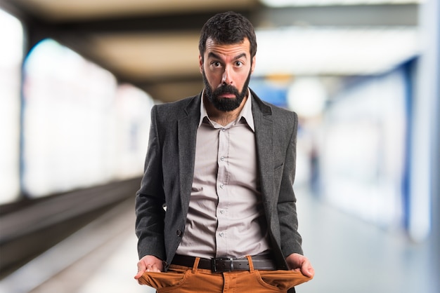 Ruined man looking money in their pockets on unfocused background