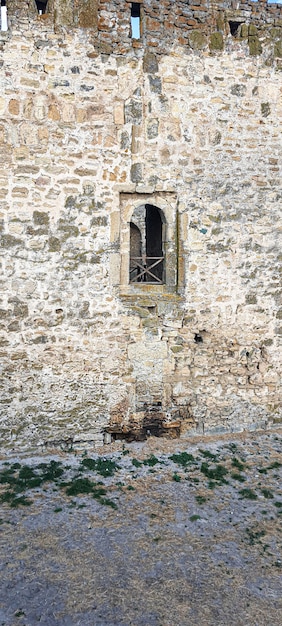 Ruined old fortress on the seashore. Blue sky. Architectural monument. Summer sea landscape.