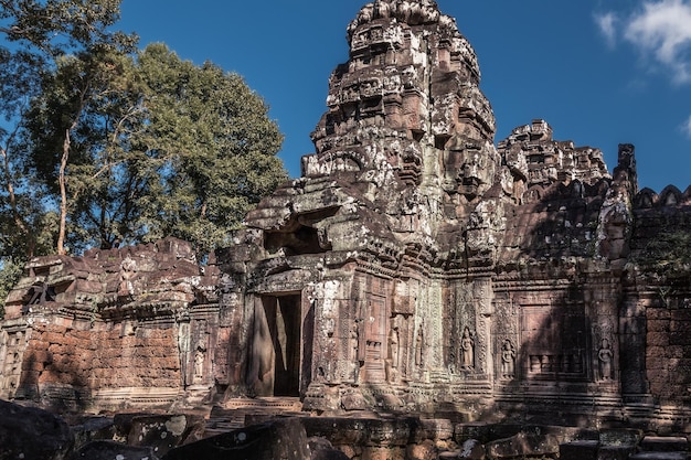 Ruins of ancient Cambodian temple among trees in Angkor complex Siem Reap Cambodia