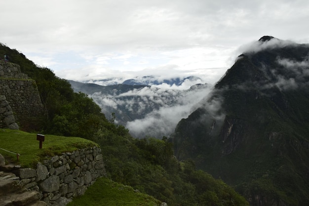 Ruins of the ancient Inca city machu picchu in fog Peru