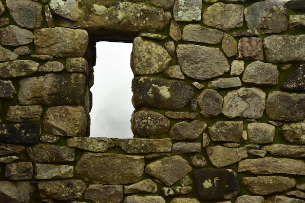 Photo ruins of the ancient inca city machu picchu in fog peru