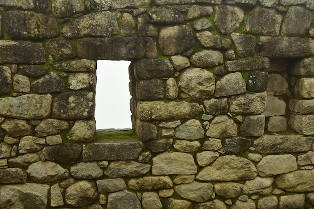 Ruins of the ancient Inca city machu picchu in fog Peru