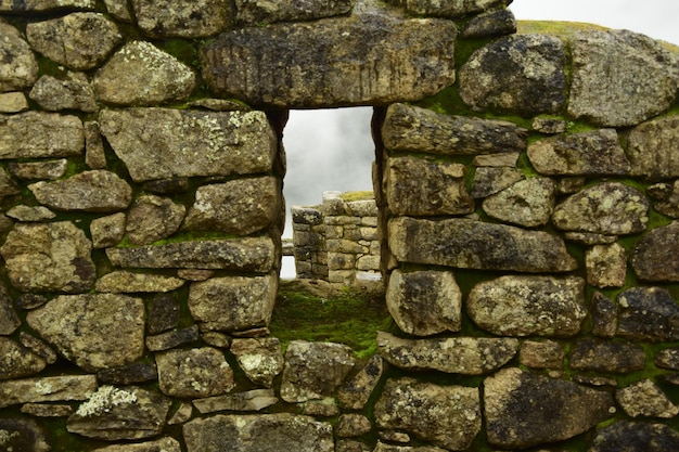 Ruins of the ancient Inca city machu picchu in fog Peru