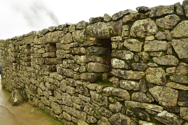 Ruins of the ancient Inca city machu picchu in fog Peru