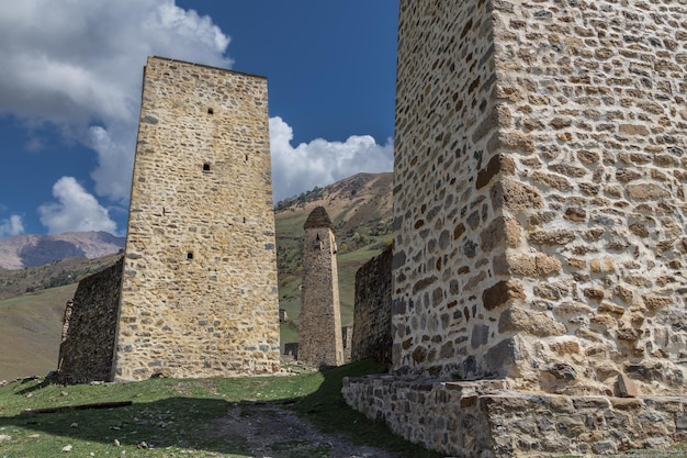 Ruins of an ancient Ingush mountain village with stone towers and houses Ingushetia Russia