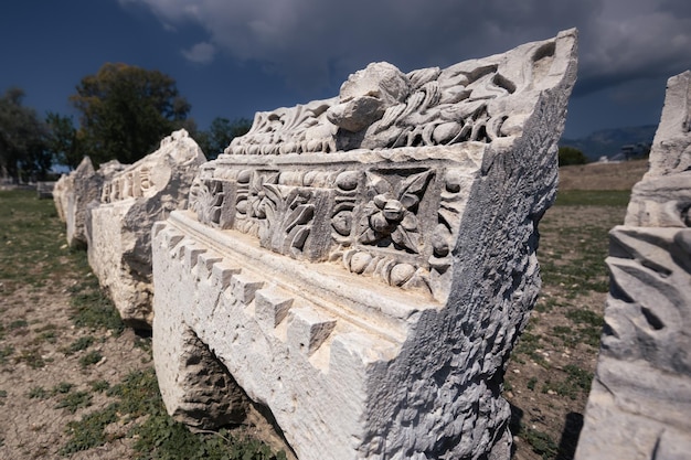 Ruins of antique Lycian religious site Letoon with remains of stone building parts Mugla Turkey