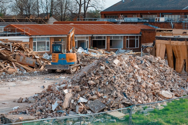 Photo ruins of a demolished building dismantling an old building pile of rubble at demolishing site