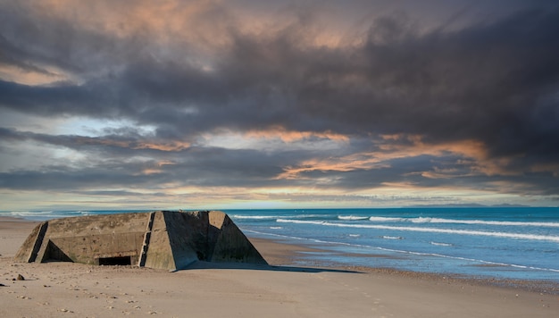 Ruins of a german bunker in the beach of Normandy, France