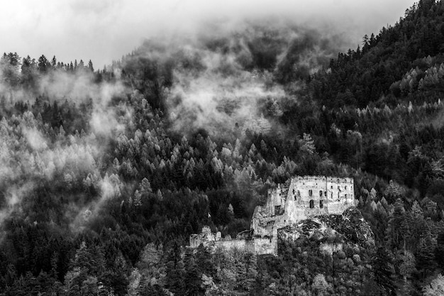 Ruins of Likava castle and autumn forest at background