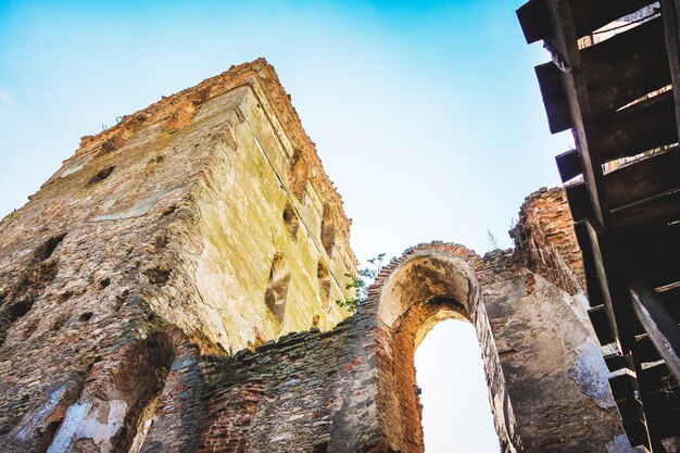 The ruins of the old fortress - a tower and a wall with an arch