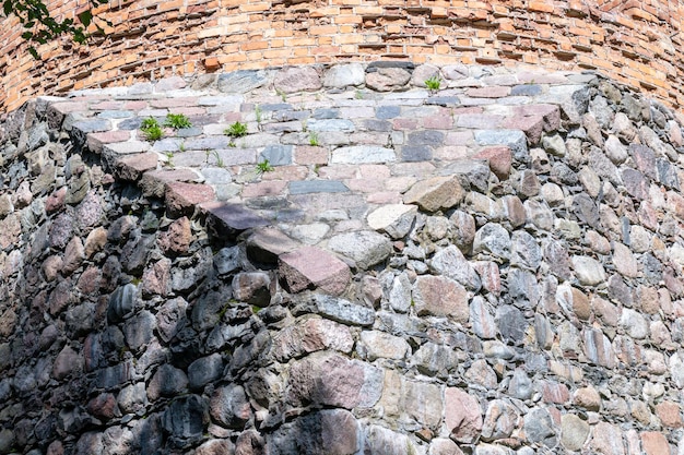 ruins of the old town with a stone and red brick wall in a triangular shape