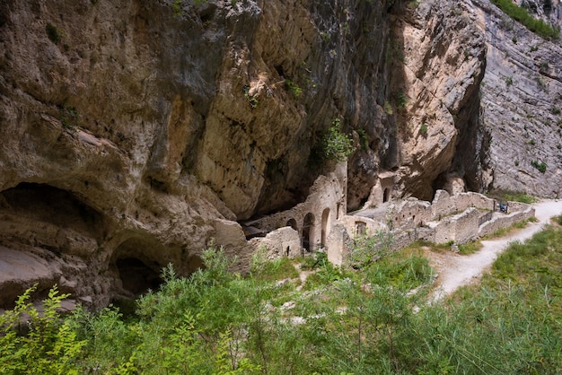 Ruins of a remote monastery in a narrow mountain valley in Italy