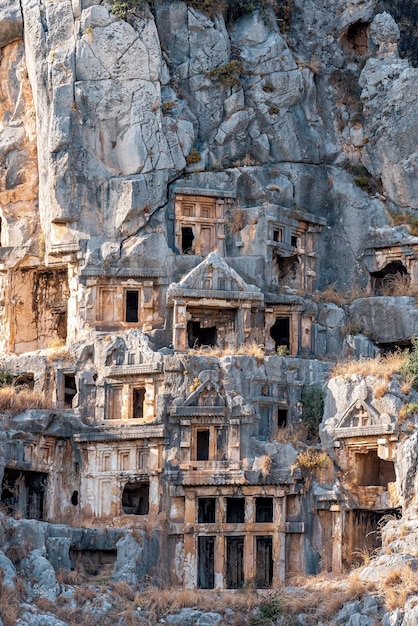 Ruins of a rocky necropolis with tombs carved in stone in Myra Lycian