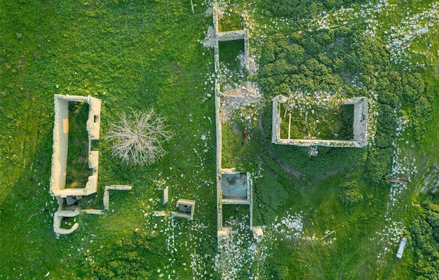 Ruins of traditional stone buildings in abandoned village drone view directly above