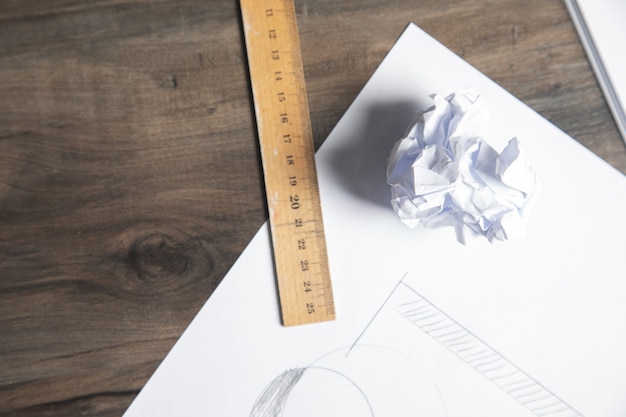 A ruler and crumpled paper on the table