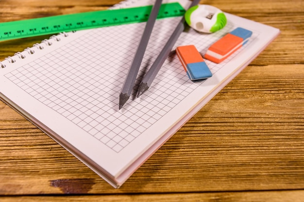 Rulers, pencils and erasers on a wooden table