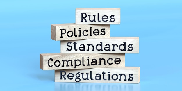 Rules policies standards compliance regulations words on wooden blocks