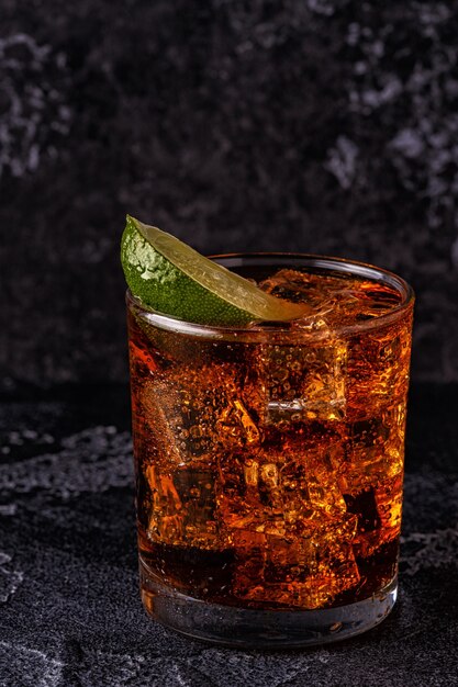 Rum and cola cuba libre with lime and ice