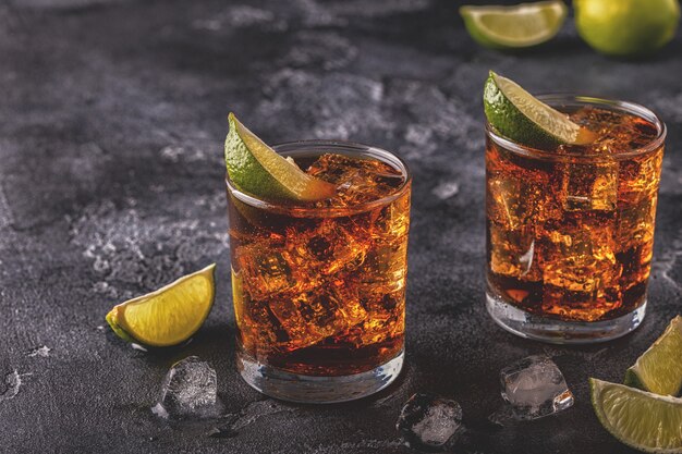 Rum and cola cuba libre with lime and ice