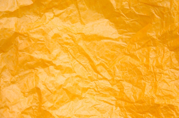 Photo rumpled yellow background. real texture of the wrapping texture.