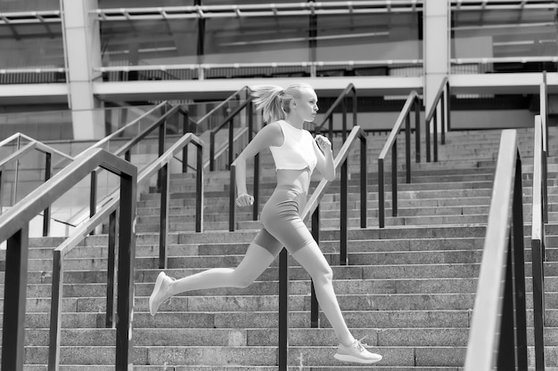 Run like beast look like beauty energetic woman run at stadium\
fast run fit athlete in sexy sportswear athletic female runner\
training and workout fitness and sport motivation run some\
more