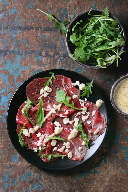 Rundercarpaccio met rucola en saus