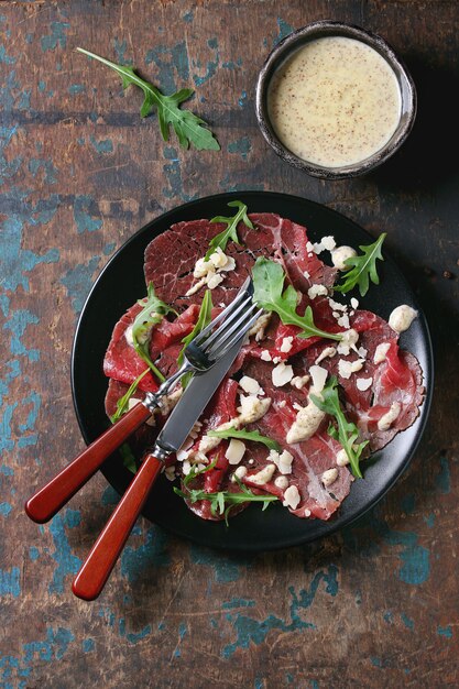 Rundercarpaccio met rucola en saus