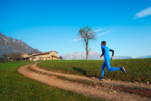 Runner athlete professional training on a mountain dirt