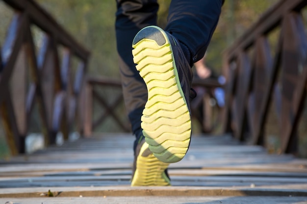 Runner feet running at park closeup on shoe