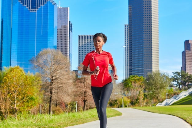 Runner girl running listening music earphones