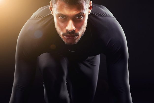 Photo runner man start and isolated portrait or run race and intense focus in dark studio background serious athlete and running training cardio and fitness motivation to win workout or exercise