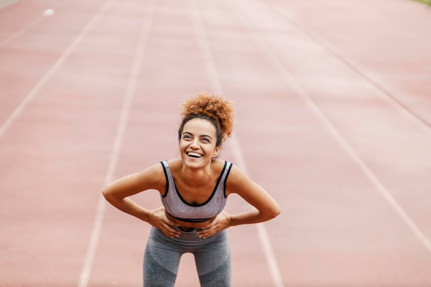 Runner resting on a track