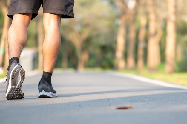 runner running on the road outside. athlete jogging and exercise on footpath 