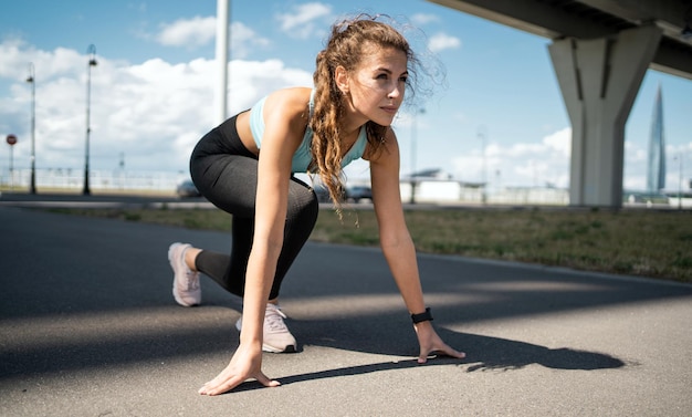 Runner slender young woman aerobics workout in comfortable clothes and sneakers